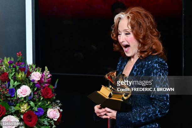 Musician Bonnie Raitt holds the awards for Best Americana Performance, Best American Roots Song, and Song of the Year for Just Like That in the press...