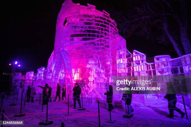 People walk along the ice palace of the Carnival Man during Quebec's annual Winter Carnival in Quebec City, Canada, on February 4, 2023. - The Quebec...