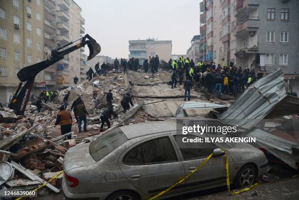 People search for survivors in Diyarbakir, on February 6 after a 7.8-magnitude earthquake struck the country's south-east. At least 284 people died...