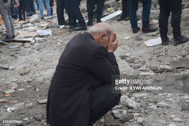 Man reacts as people search for survivors through the rubble in Diyarbakir, on February 6 after a 7.8-magnitude earthquake struck the country's...