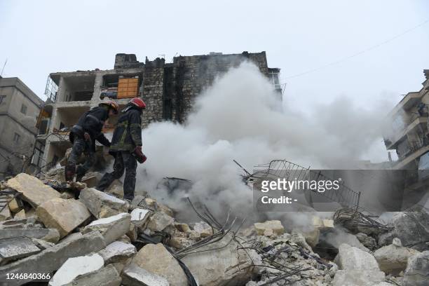 Rescue teams look for survivors under the rubble of a collapsed building after an earthquake in the regime-controlled northern Syrian city of Aleppo...