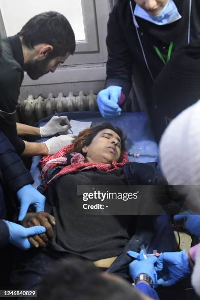 Medics tend to a wounded woman after an earthquake at the emergency ward of a hospital in the regime-controlled northern Syrian city of Aleppo on...