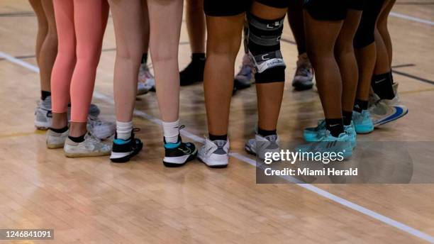 The Miami Palmetto Senior High School Lady Panthers huddle before the start of their basketball game against the Miami Senior High School Lady Stings...