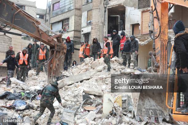 Syrian rescue teams look for survivors under the rubble after a 7.8 magnitude earthquake in the government-controlled central Syrian city of Hama on...