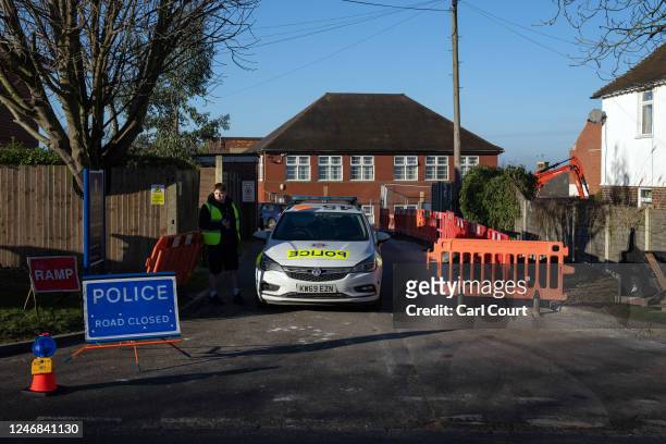 Police car is parked at an entrance to Epsom College after the school's head, Emma Pattison, was found dead alongside her family yesterday, on...
