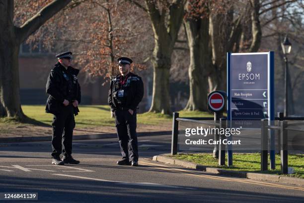 Police officers stand guard inside Epsom College after the school's head, Emma Pattison, was found dead alongside her family yesterday, on February...