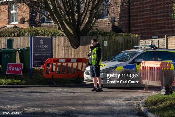 Police car is parked at an entrance to Epsom College after the school's head, Emma Pattison, was found dead alongside her family yesterday, on...