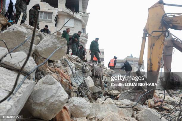 Syrian rescue teams search for survivors under the rubble after an earthquake in the government-controlled central Syrian city of Hama on February 6,...