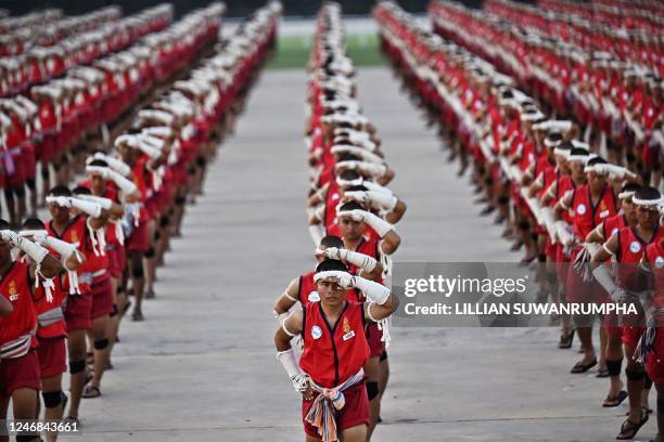 Muay Thai fighters perform the traditional Wai Kru ceremony during a festival for the Thai martial art in Rajabhakti Park in Hua Hin on February 6 as...