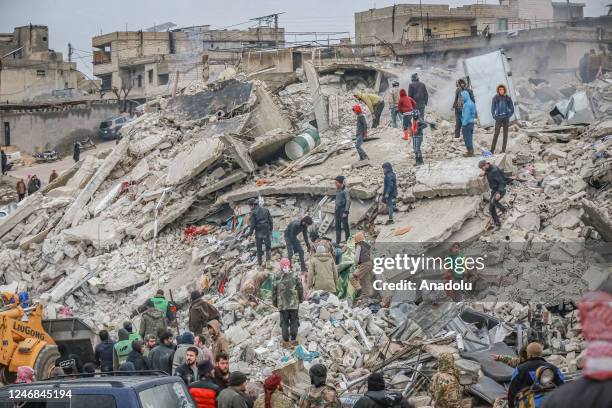 Personnel and civilians conduct search and rescue operations in Idlib, Syria after a 7.7 magnitude earthquake hits Turkiye's Kahramanmaras, on...