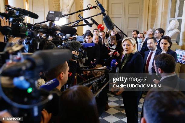 French far-right Rassemblement National parliamentary group president Marine Le Pen , flanked by French far-right Rassemblement National party MP...