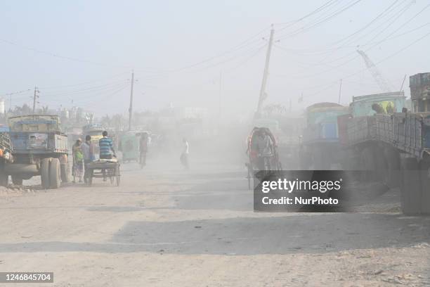 People make their move in a dusty road in Dhaka, Bangladesh, on February 6, 2023. Dhaka ranked first in the list of cities with the worst air.