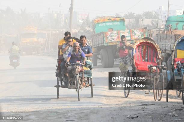 People make their move in a dusty road in Dhaka, Bangladesh, on February 6, 2023. Dhaka ranked first in the list of cities with the worst air.