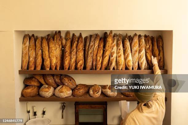 An employee sorts baguettes at L'Appartement 4F, a French bakery famous for their Petite Croissant Cereale, on February 4, 2023 in the Brooklyn...