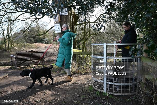 Dog walker passes a bench where the phone and dog's harness of missing Nicola 'Nikki' Bulley were discovered, by the banks of the River Wyre, in St...