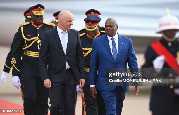 Swiss President Alain Berset walks along Botswana President Dr Mokgweetsi Masisi upon his arrival at the Sir Seretse Khama International Airport in...