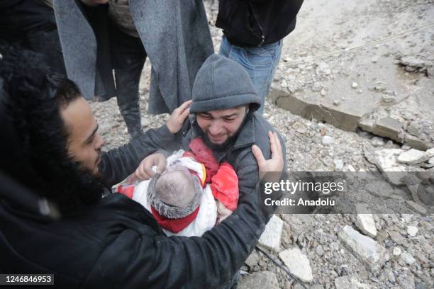 Man cries while holding his baby who died in the earthquake in Afrin district of Aleppo, Syria after 7.7 and 7.6 magnitude earthquakes hits Turkiye's...