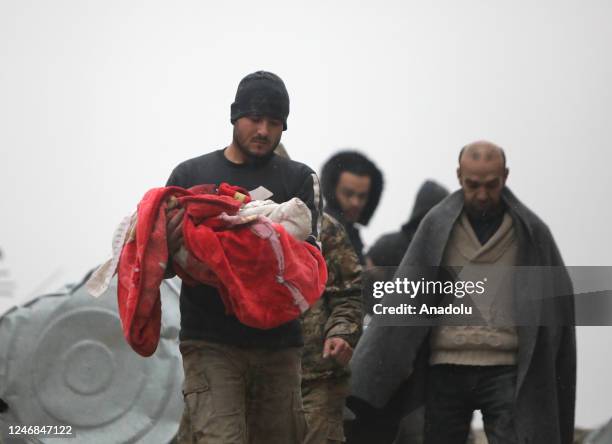 Man carries the dead body of a baby who died under the rubble in the earthquake in Afrin district of Aleppo, Syria after 7.7 and 7.6 magnitude...