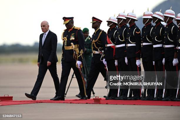 Swiss President Alain Berset inspects a guard of honour mounted by the Botswana defence force soldiers on his arrival at the Sir Seretse Khama...