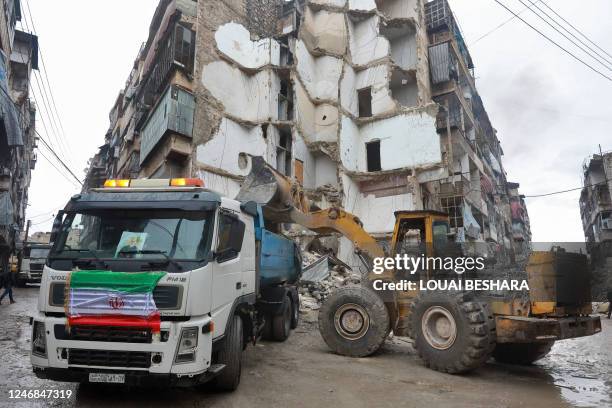 Graphic content / A truck adorned with Iran's flag takes part in the search operations following a deadly earthquake on February 6 in the city of...