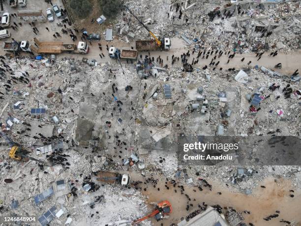 An aerial view of a collapsed buildings as personnel and civilians conduct search and rescue operations in Idlib, Syria after 7.7 and 7.6 magnitude...