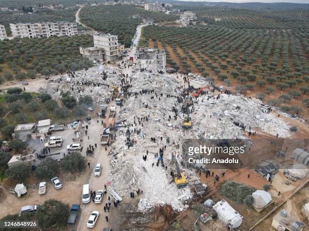 An aerial view of a collapsed buildings as personnel and civilians conduct search and rescue operations in Idlib, Syria after 7.7 and 7.6 magnitude...