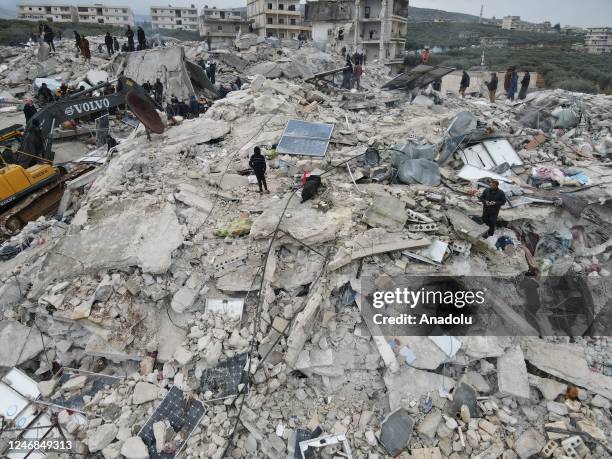 An aerial view of a collapsed buildings as personnel and civilians conduct search and rescue operations in Idlib, Syria after 7.7 and 7.6 magnitude...