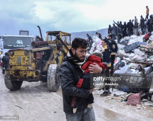 Man carries the dead body of a baby who died under the rubble in the earthquake in Idlib, Syria after 7.7 and 7.6 magnitude earthquakes hits...