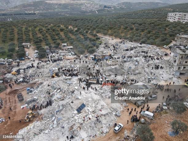 An aerial view of a collapsed buildings as personnel and civilians conduct search and rescue operations in Idlib, Syria after 7.7 and 7.6 magnitude...