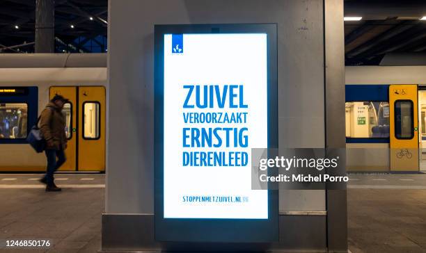 Poster saying 'Dairy causes severe animal suffering', the message of this Stop With Dairy campaign poster at this train station, is seen after Dutch...