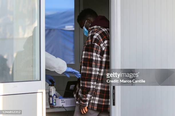 Migrant during checks after landing in Naples, from the Sea-Eye 4 rescue ship, after being rescued from a shipwreck in the Mediterranean sea.