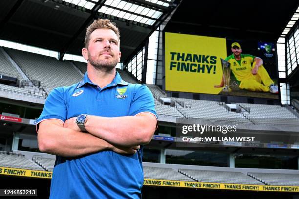 Australian cricket player Aaron Finch poses for photos after announcing his retirement from international cricket at the Melbourne Cricket Ground in...