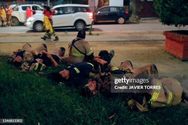 Firefighters rest at the command post after fighting forest fires in Santa Juana, Concepcion province, Chile on February 6, 2023. - The fires, which...