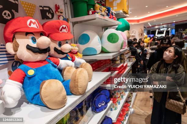 This picture taken on February 5, 2023 shows people visiting a store of game giant Nintendo in Tokyo. - Nintendo were expected to announce their...