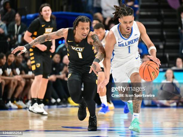 Saint Louis University guard Yuri Collins drives to the basket as VCU guard Ace Baldwin Jr defends during a college basketball game between the VCU...