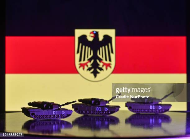 Illustration of a mini replica of Leopard tanks and figures of soldats, seen in front of the German flag, displayed on a computer screen. On...