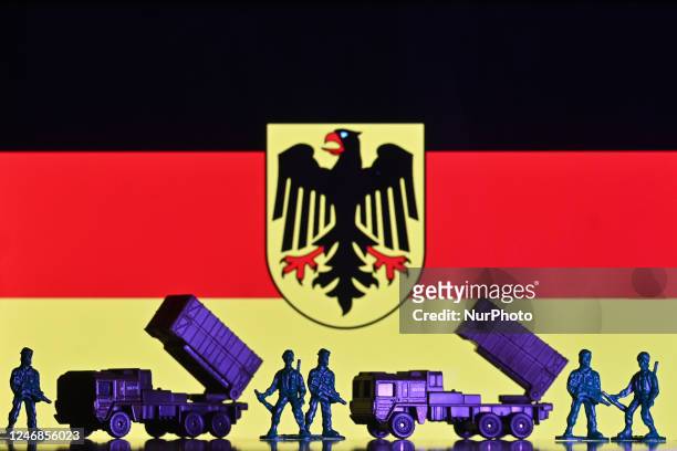 Illustration of a mini replica of MIM-104 Patriot, a surface-to-air missile system and and figures of soldiers, seen in front of the German flag,...