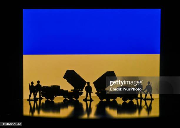 Illustration of a mini replica of MIM-104 Patriot, a surface-to-air missile system and and figures of soldiers, seen in front of the Ukrainian...