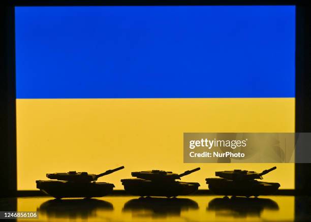 Illustration of a mini replica of Leopard tanks in front of the Ukrainian National flag displayed on a computer screen. On Tuesdayy, February 07 in...