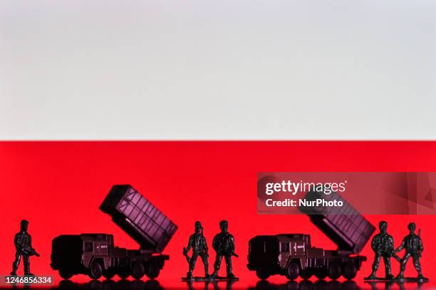 Illustration of a mini replica of MIM-104 Patriot, a surface-to-air missile system and and figures of soldats, seen in front of the Polish flag,...