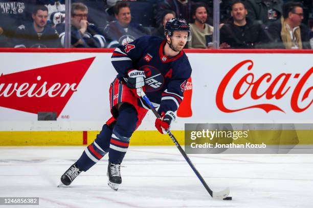 Josh Morrissey of the Winnipeg Jets plays the puck during first period action against the St. Louis Blues at Canada Life Centre on January 30, 2023...