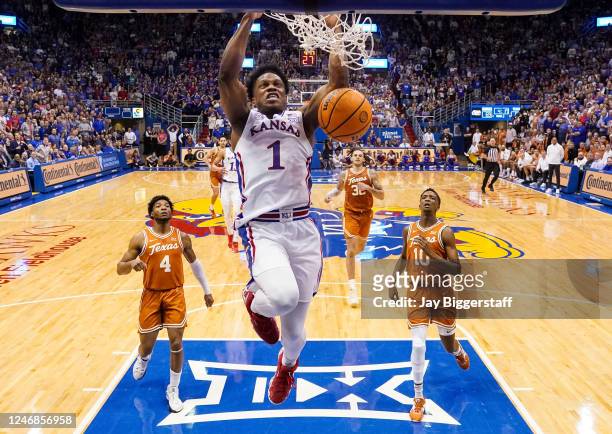 Joseph Yesufu of the Kansas Jayhawks dunks the ball against Tyrese Hunter and SirJabari Rice of the Texas Longhorns during the second half at Allen...