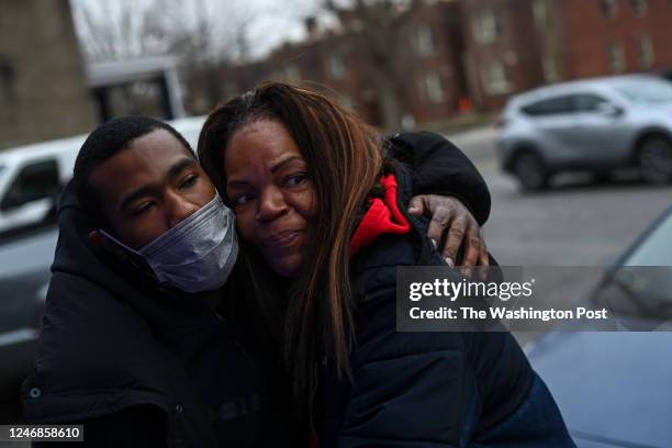Karen Hylton, mother of Karon Hylton receives a hug from one of her sons friend Ta-Juan Lee in the Brightwood Park neighborhood on February 12, 2021...