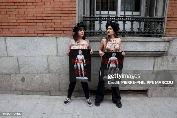 Femen activists hold sign reading 'Only yes is yes' as they demonstrate in front of Spain's Ministry of Justice in Madrid on February 7, 2023. -...