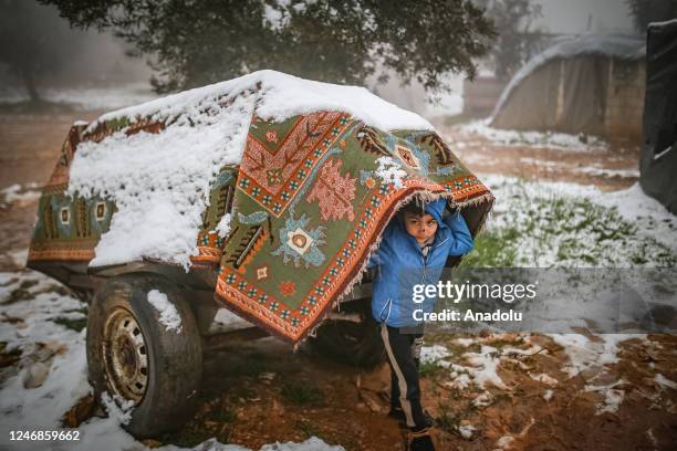 Child carry a dray at Sendiyan Refugee Camp, where civilians are displaced by the attacks of Bashar Assad regime as they live in tents with harsh...