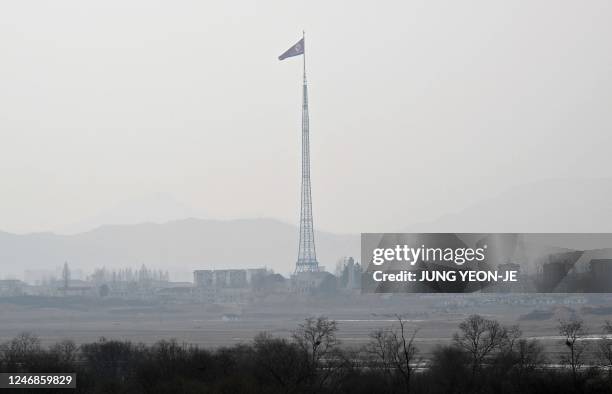 North Korean flag flutters in the wind at the propaganda village of Gijungdong in North Korea as seen from a South Korean checkpoint during a media...