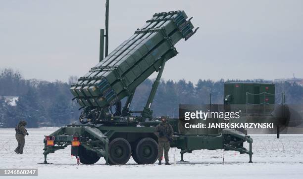 Soldier stands in front of a PATRIOT surface-to-air missile system during a military exercise at Warsaw Babice Airport, Poland on February 7, 2023. -...