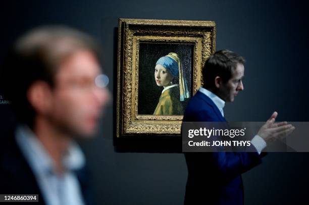 General Director of the Rijksmuseum Taco Dibbits speaks to journalists as he stands in front of a painting by the Dutch master Johannes Vermeer...