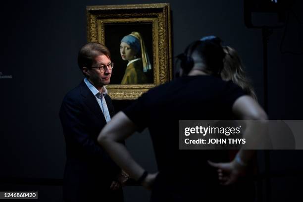 General Director of the Rijksmuseum Taco Dibbits speaks to journalists as he stands in front of a painting by the Dutch master Johannes Vermeer...