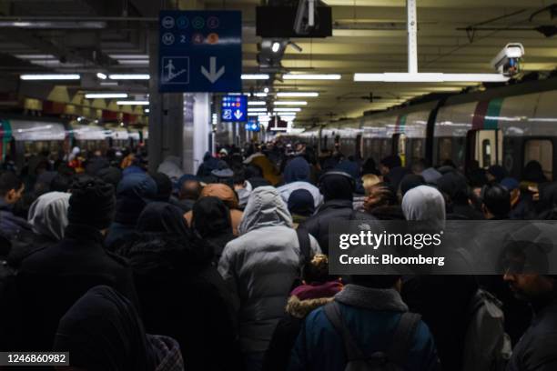 Crowds of passengers alight a Metro RER subway train at Gare du Nord during limited rail services due to a strike against pension reform in Paris,...